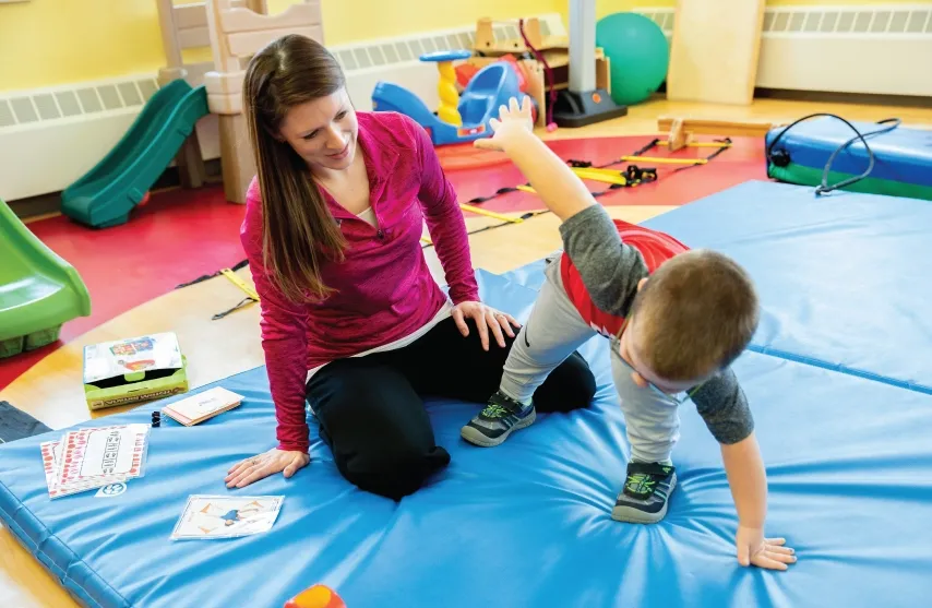 A woman interacting with a young child.